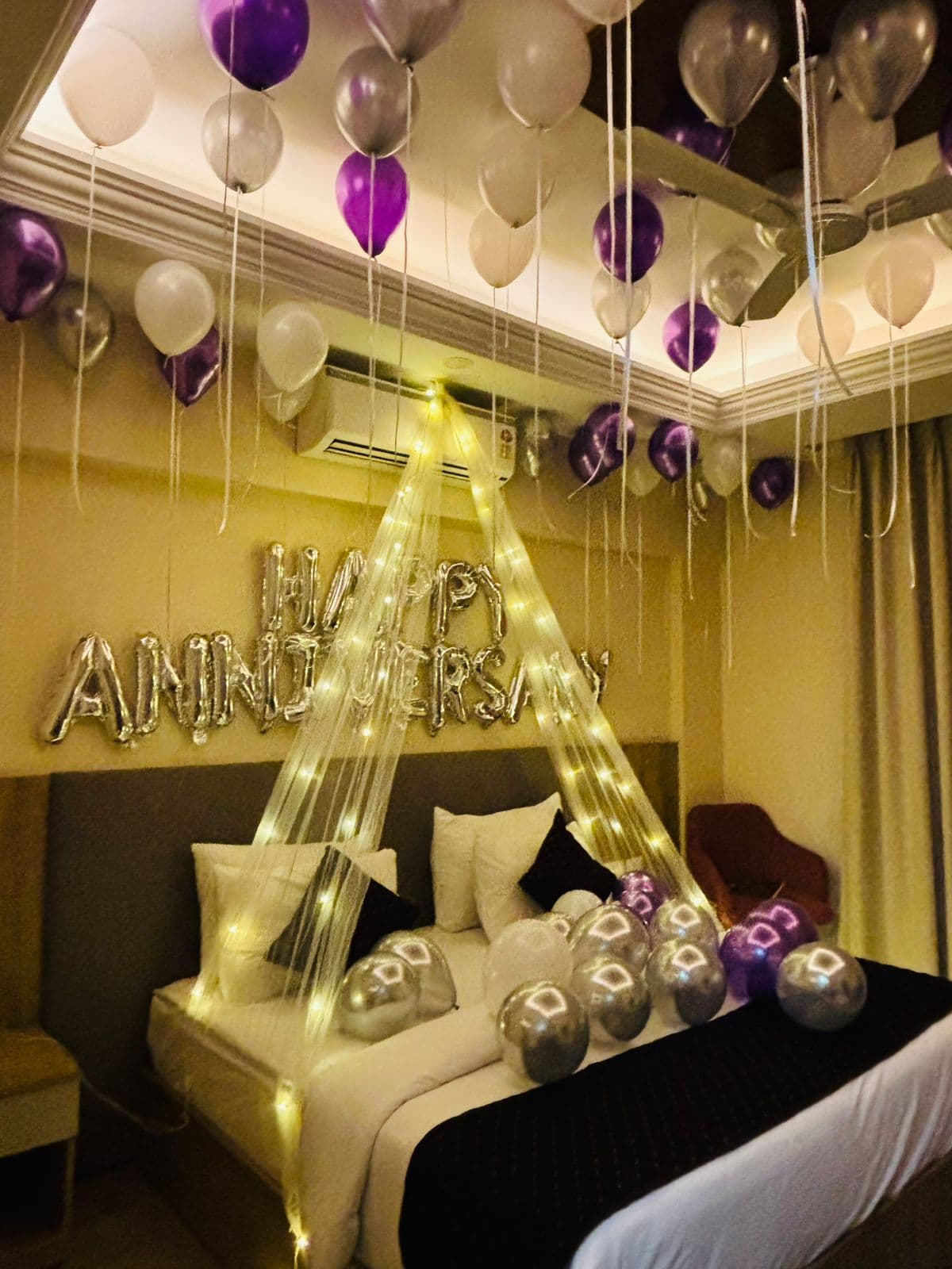 Romantic canopy and balloon decoration set up inside a Delhi home
