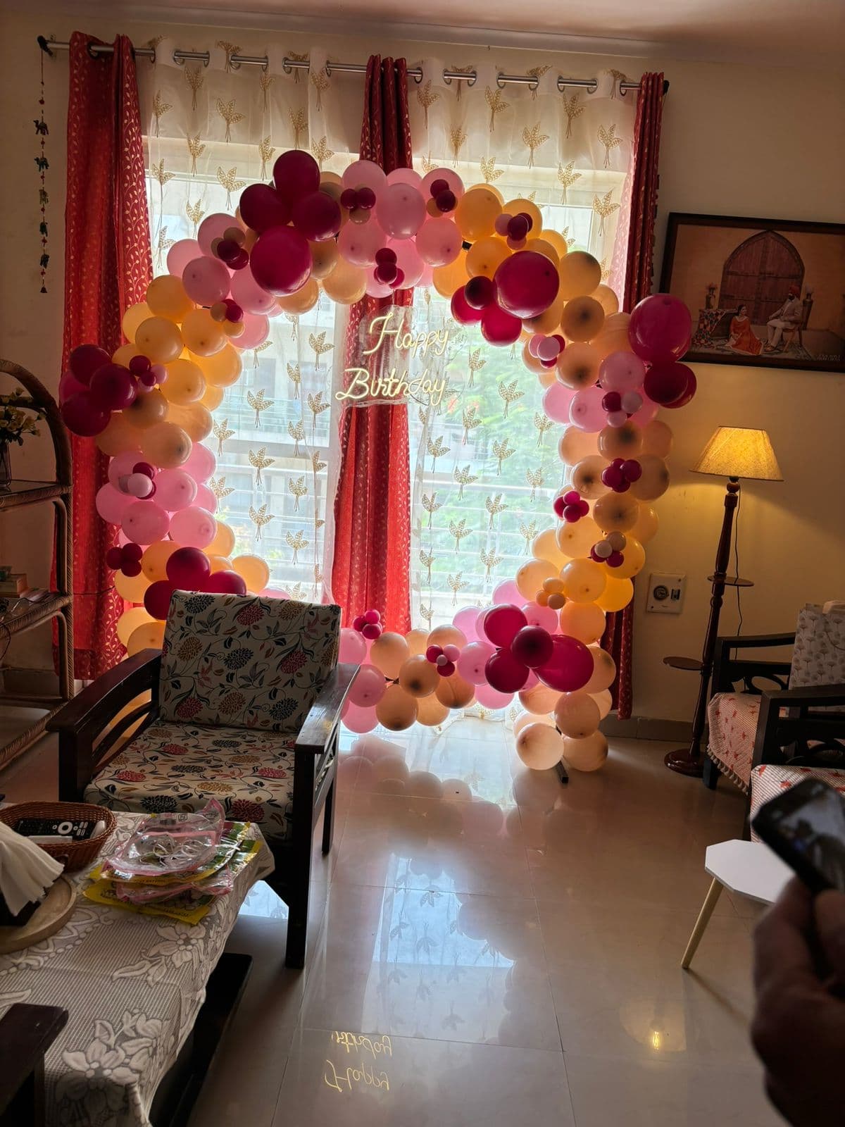 Pink, magenta and peach balloon ring styled in a living room